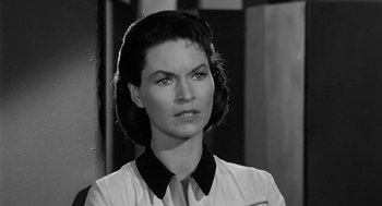 Movie still from “It! The Terror from Beyond Space” (1958), directed by Edward L. Cahn – A black - and - white photo of a woman in a white shirt; Close Up shot, High angle