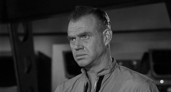 Movie still from “It! The Terror from Beyond Space” (1958), directed by Edward L. Cahn – An old photo of a man in a black and white photo; Close Up shot, Low angle