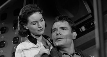 Movie still from “It! The Terror from Beyond Space” (1958), directed by Edward L. Cahn – A man and a woman are looking at each other; Close Up shot, Low angle