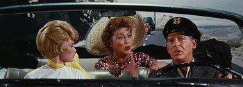 Movie still from “It's a Mad Mad Mad Mad World” (1963), directed by Stanley Kramer – An older woman driving a car with a large hat on; Close Up shot, High angle