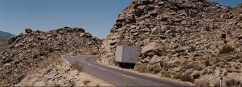 Movie still from “It's a Mad Mad Mad Mad World” (1963), directed by Stanley Kramer – A truck is parked on the side of the road; Extreme Wide shot, High angle