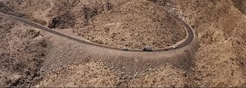 Movie still from “It's a Mad Mad Mad Mad World” (1963), directed by Stanley Kramer – An aerial view of a truck on the side of the road; Extreme Wide shot, Overhead angle