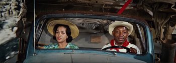 Movie still from “It's a Mad Mad Mad Mad World” (1963), directed by Stanley Kramer – A man and a woman sitting in the back of a car; Medium shot, Low angle