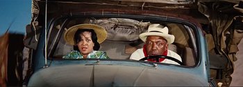 Movie still from “It's a Mad Mad Mad Mad World” (1963), directed by Stanley Kramer – An older man and a woman in a car; Medium shot, High angle