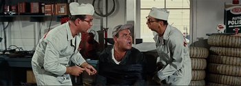 Movie still from “It's a Mad Mad Mad Mad World” (1963), directed by Stanley Kramer – A group of men standing next to each other in a room; Medium shot, High angle