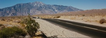Movie still from “It's a Mad Mad Mad Mad World” (1963), directed by Stanley Kramer – A truck driving down a road in the middle of the desert; Extreme Wide shot, High angle