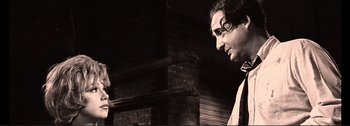 Movie still from “It's a Mad Mad Mad Mad World” (1963), directed by Stanley Kramer – A man standing next to a brick wall; Close Up shot, Low angle