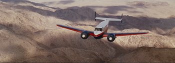 Movie still from “It's a Mad Mad Mad Mad World” (1963), directed by Stanley Kramer – An airplane is flying in the sky over the mountains; Extreme Wide shot, Low angle