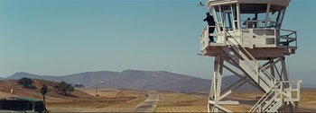 Movie still from “It's a Mad Mad Mad Mad World” (1963), directed by Stanley Kramer – An airplane taking off from a runway in the middle of nowhere; Extreme Wide shot, Low angle