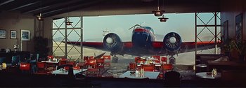 Movie still from “It's a Mad Mad Mad Mad World” (1963), directed by Stanley Kramer – An airplane sitting on top of an airport runway; Extreme Wide shot, Low angle