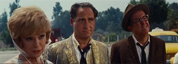 Movie still from “It's a Mad Mad Mad Mad World” (1963), directed by Stanley Kramer – A person wearing a suit and tie; Close Up shot, Low angle