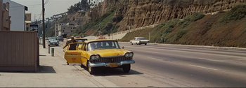 Movie still from “It's a Mad Mad Mad Mad World” (1963), directed by Stanley Kramer – An old yellow taxi cab driving down the street; Extreme Wide shot, Low angle