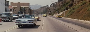 Movie still from “It's a Mad Mad Mad Mad World” (1963), directed by Stanley Kramer – Cars are driving down the street in a city; Extreme Wide shot, High angle