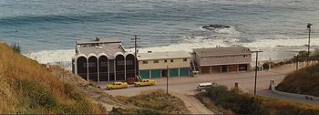 Movie still from “It's a Mad Mad Mad Mad World” (1963), directed by Stanley Kramer – A couple of cars parked on the side of a road; Extreme Wide shot, High angle