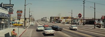Movie still from “It's a Mad Mad Mad Mad World” (1963), directed by Stanley Kramer – Cars driving down a street in the middle of a city; Extreme Wide shot, High angle