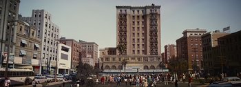 Movie still from “It's a Mad Mad Mad Mad World” (1963), directed by Stanley Kramer – A large group of people standing in front of a tall building; Extreme Wide shot, High angle