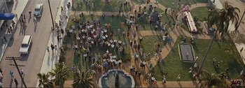 Movie still from “It's a Mad Mad Mad Mad World” (1963), directed by Stanley Kramer – An aerial view of a crowd of people gathered around a fountain; Extreme Wide shot, Overhead angle