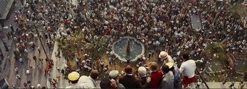 Movie still from “It's a Mad Mad Mad Mad World” (1963), directed by Stanley Kramer – An aerial view of a crowd of people gathered around a fountain; Extreme Wide shot, Overhead angle