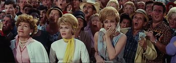 Movie still from “It's a Mad Mad Mad Mad World” (1963), directed by Stanley Kramer – A group of people that are sitting in a crowd; Medium shot, Low angle