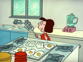 Movie still from “It's the Easter Beagle, Charlie Brown!” (1974), directed by Phil Roman – An animated woman holding a spatula in a kitchen; Medium shot, Low angle