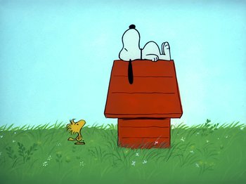 Movie still from “It's the Easter Beagle, Charlie Brown!” (1974), directed by Phil Roman – A dog sitting on top of a house next to a bird; Extreme Wide shot, Low angle