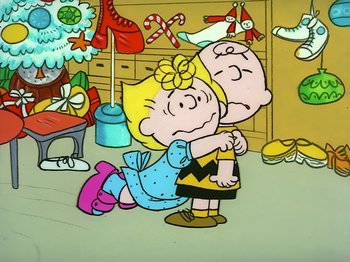 Movie still from “It's the Easter Beagle, Charlie Brown!” (1974), directed by Phil Roman – A charlie brown and sally hugging each other in a room; Extreme Wide shot, High angle