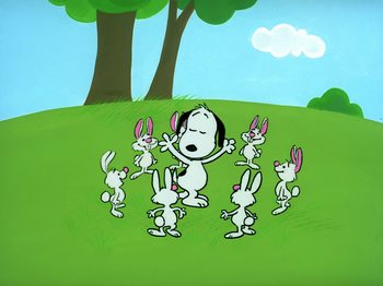 Movie still from “It's the Easter Beagle, Charlie Brown!” (1974), directed by Phil Roman – A group of rabbits standing in a grassy field; Wide shot, High angle
