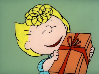 Movie still from “It's the Easter Beagle, Charlie Brown!” (1974), directed by Phil Roman – A drawing of a girl holding a gift box; Medium shot, Overhead angle