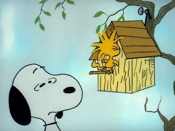 Movie still from “It's the Easter Beagle, Charlie Brown!” (1974), directed by Phil Roman – A painting of a dog and a bird in a birdhouse; Extreme Wide shot, Low angle