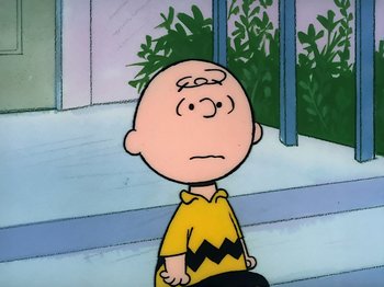 Movie still from “It's the Easter Beagle, Charlie Brown!” (1974), directed by Phil Roman – A charlie brown character sitting in front of a window; Close Up shot, High angle