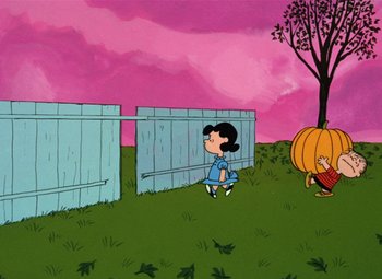 Movie still from “It's the Great Pumpkin, Charlie Brown” (1966), directed by Bill Melendez – A girl sitting on the ground in front of a fence; Extreme Wide shot, Low angle