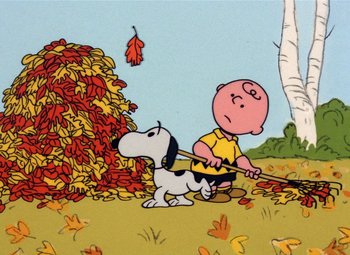 Movie still from “It's the Great Pumpkin, Charlie Brown” (1966), directed by Bill Melendez – A charlie brown and snoopy cartoon scene with leaves falling; Extreme Wide shot, High angle