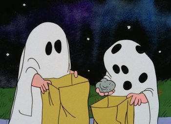 Movie still from “It's the Great Pumpkin, Charlie Brown” (1966), directed by Bill Melendez – A couple of people that are dressed like ghosts; Medium shot, High angle