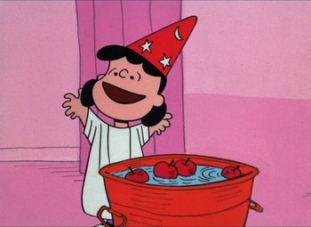 Movie still from “It's the Great Pumpkin, Charlie Brown” (1966), directed by Bill Melendez – A charlie brown character is standing in front of a bowl of apples; Medium shot, High angle