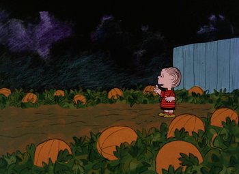 Movie still from “It's the Great Pumpkin, Charlie Brown” (1966), directed by Bill Melendez – A charlie brown character standing in a pumpkin patch; Extreme Wide shot, High angle
