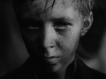 Movie still from “Ivan's Childhood” (1962), directed by Eduard Abalov – A person's face with water on them; Close Up shot, High angle