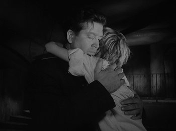 Movie still from “Ivan's Childhood” (1962), directed by Eduard Abalov – A black and white photo of a man holding a little girl; Medium shot, High angle
