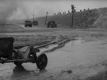 Movie still from “Ivan's Childhood” (1962), directed by Eduard Abalov – A black - and - white photo of a cart in the middle of a road; Extreme Wide shot, High angle