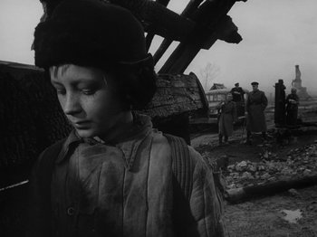 Movie still from “Ivan's Childhood” (1962), directed by Eduard Abalov – An old photo of a young boy in front of a building; Close Up shot, Low angle