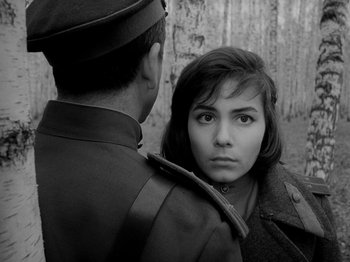 Movie still from “Ivan's Childhood” (1962), directed by Eduard Abalov – A man and a woman in military uniforms looking at one another; Close Up shot, Over the shoulder angle