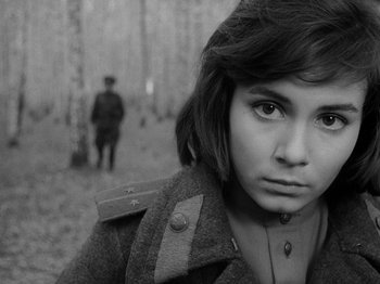Movie still from “Ivan's Childhood” (1962), directed by Eduard Abalov – A young woman in a military uniform in the woods; Close Up shot, High angle