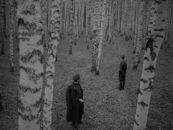 Movie still from “Ivan's Childhood” (1962), directed by Eduard Abalov – Two men standing in the middle of a forest; Wide shot, High angle