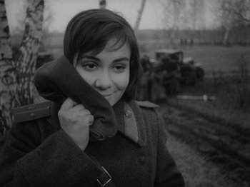 Movie still from “Ivan's Childhood” (1962), directed by Eduard Abalov – A young woman holding a phone up to her ear; Close Up shot, High angle