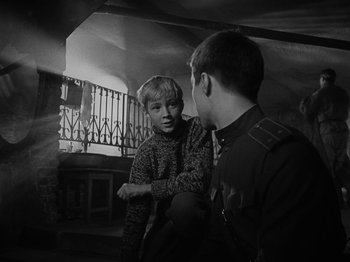 Movie still from “Ivan's Childhood” (1962), directed by Eduard Abalov – Two young boys talking to each other in a room; Medium shot, Over the shoulder angle