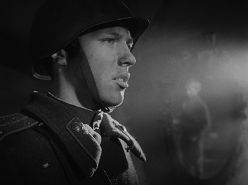 Movie still from “Ivan's Childhood” (1962), directed by Eduard Abalov – A man in a military uniform is wearing a hat and a tie; Close Up shot, Low angle