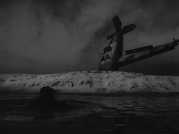 Movie still from “Ivan's Childhood” (1962), directed by Eduard Abalov – An old airplane sitting on top of a beach; Extreme Wide shot, Low angle