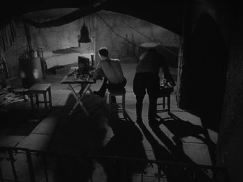 Movie still from “Ivan's Childhood” (1962), directed by Eduard Abalov – A man and a woman standing next to each other; Wide shot, High angle