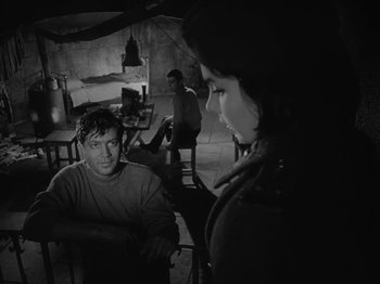 Movie still from “Ivan's Childhood” (1962), directed by Eduard Abalov – A man and a woman sitting at a table in front of another man; Medium shot, Over the shoulder angle