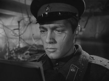 Movie still from “Ivan's Childhood” (1962), directed by Eduard Abalov – A man in a military uniform looking to his left; Close Up shot, Low angle