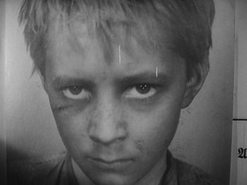 Movie still from “Ivan's Childhood” (1962), directed by Eduard Abalov – A black and white photo of a young boy; Close Up shot, High angle